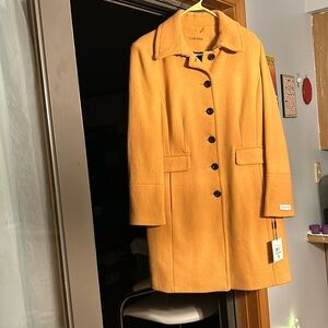 Calvin Klein winter jacket. Size 12, mustard color. Never worn. Smoke free home.